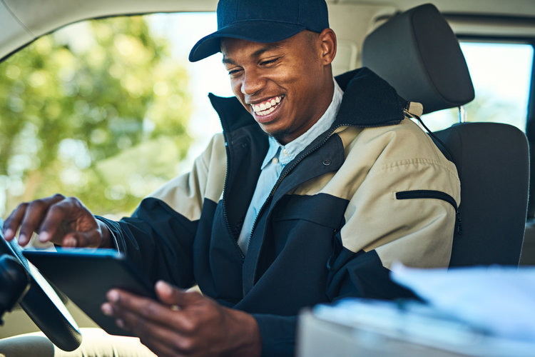 Courier driver smiling from inside vehicle